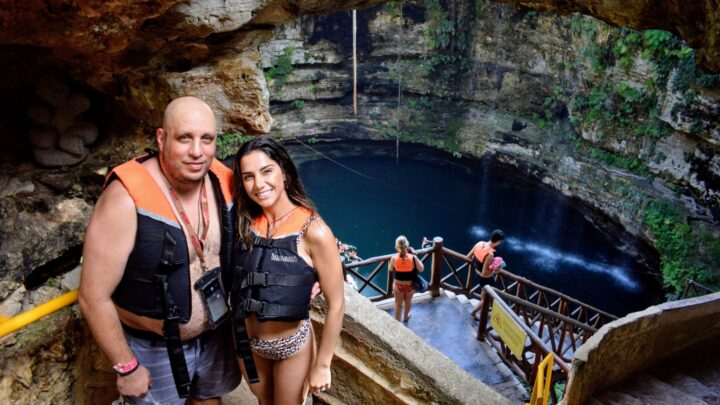 Couple enjoying a serene moment at a stunning cenote in Tulum during their private tour by Carey Tours.