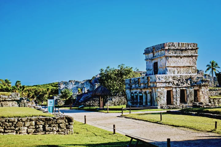 Exploring the ancient ruins of Tulum, showcasing well-preserved structures and lush surroundings by Carey Tours.