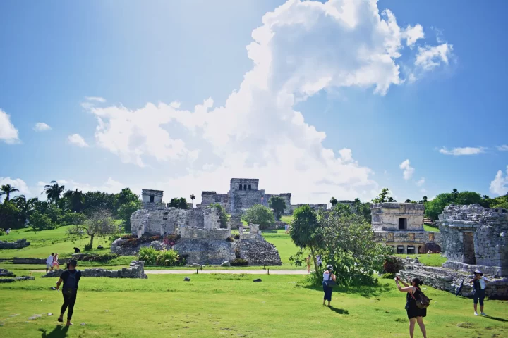 Exploring the ancient ruins of Tulum with expert insights amidst lush greenery, a serene private tour experience by Carey Tours