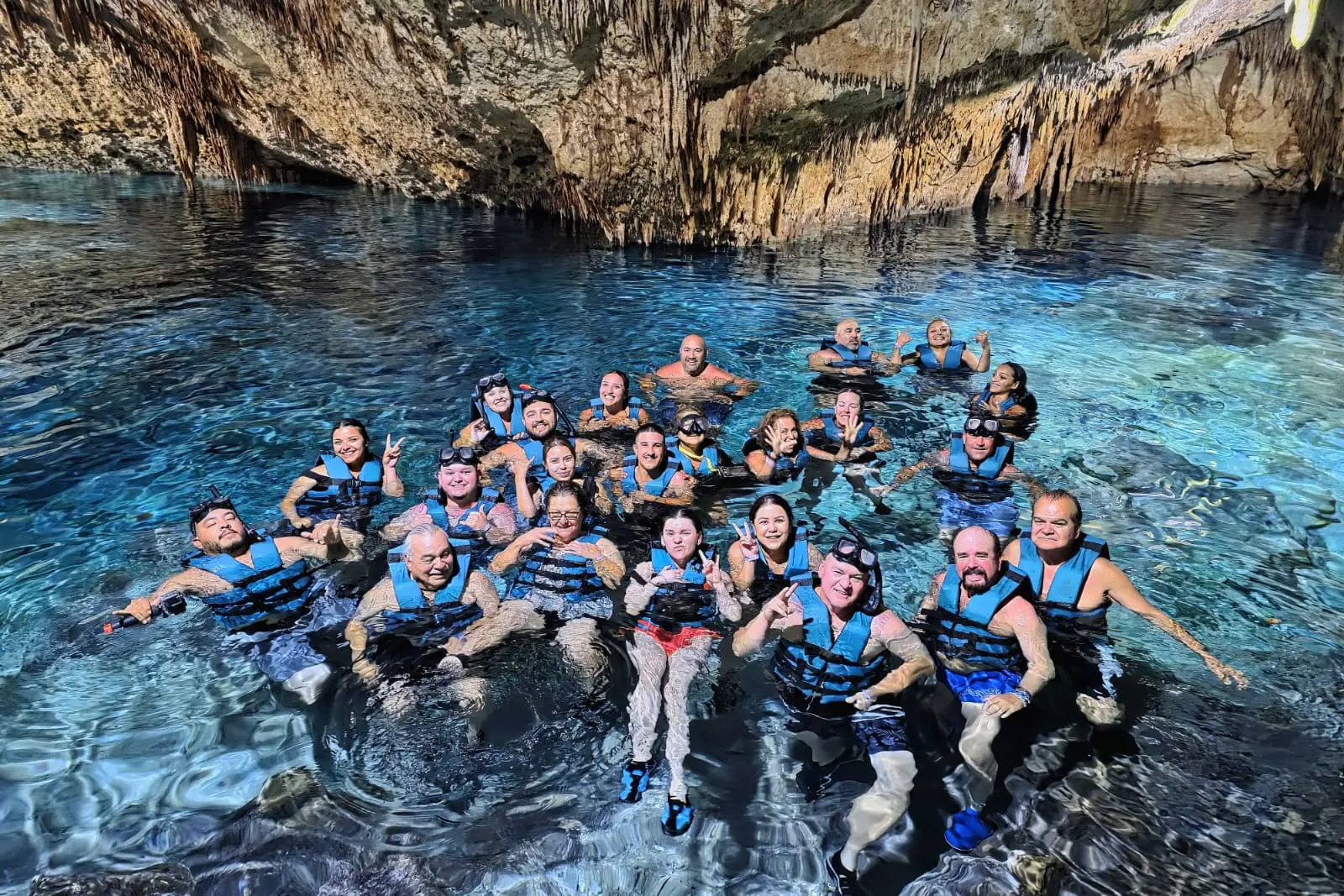 Participants enjoying a private snorkeling tour in Playa del Carmen, surrounded by vibrant marine life, led by Carey Tours