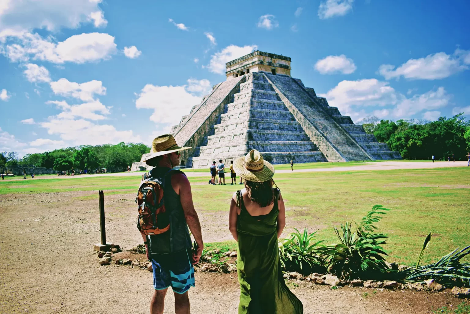 Visitors admiring the impressive El Castillo pyramid at Chichén Itzá during a private tour by Carey Tours.