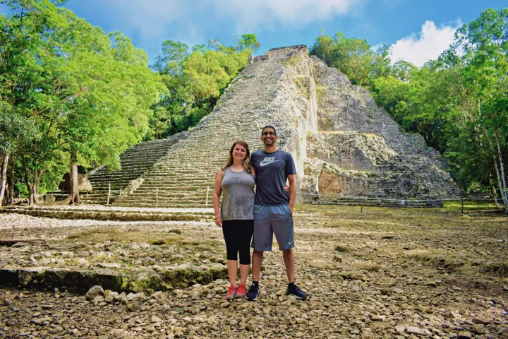 Exploring ancient ruins surrounded by lush greenery in Tulum during a private tour by Carey Tours.
