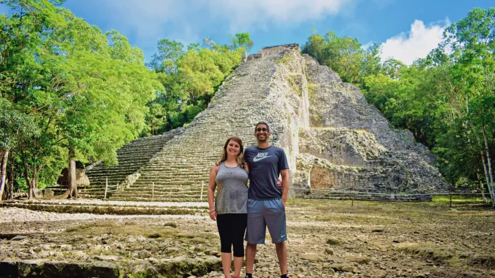 Exploring ancient ruins surrounded by lush greenery in Tulum during a private tour by Carey Tours.
