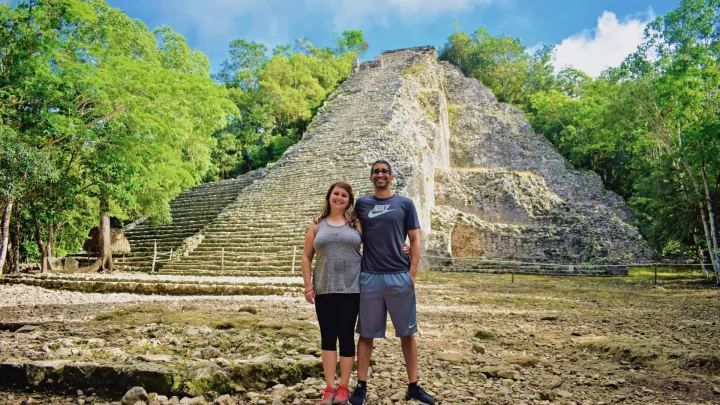 Exploring ancient ruins surrounded by lush greenery in Tulum during a private tour by Carey Tours.