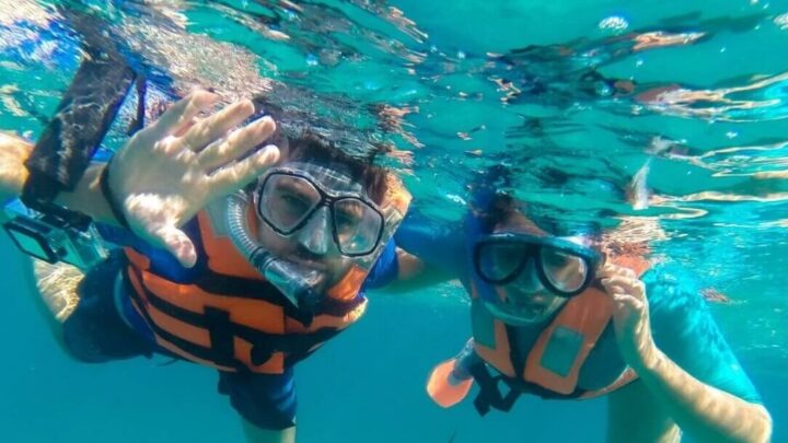 Snorkeling in vibrant waters off the coast of the Riviera Maya, Experiencing marine life up close with guidance by Carey Tours.