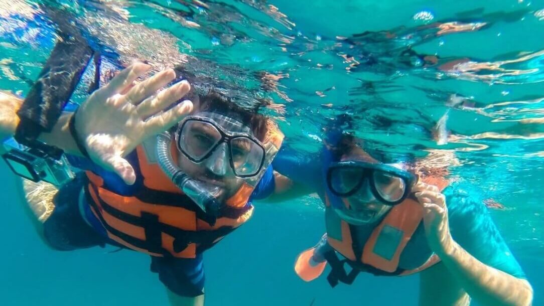 Snorkeling in vibrant waters off the coast of Tulum, experiencing marine life up close with guidance by Carey Tours.